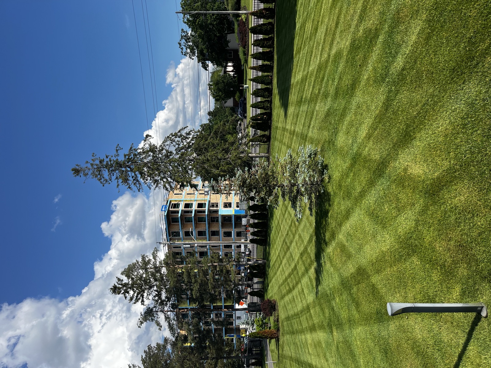 Manicured striped lawn at a commercial property entrance