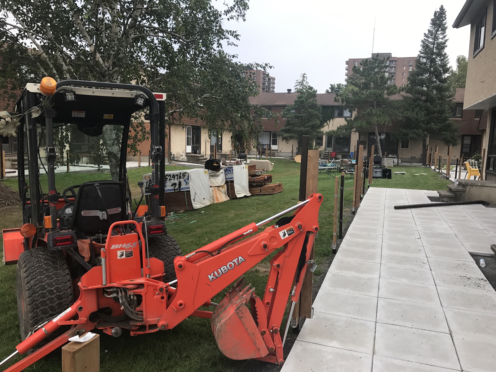 Kubota backhoe on a landscaping and interlock job site
